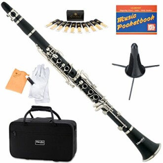 Clarinet with accessories including reeds, stand, gloves, carrying case, and music book.