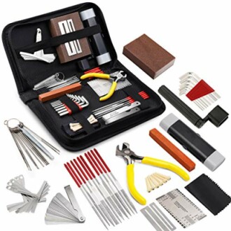 Comprehensive guitar repair tool kit with various tools and accessories.